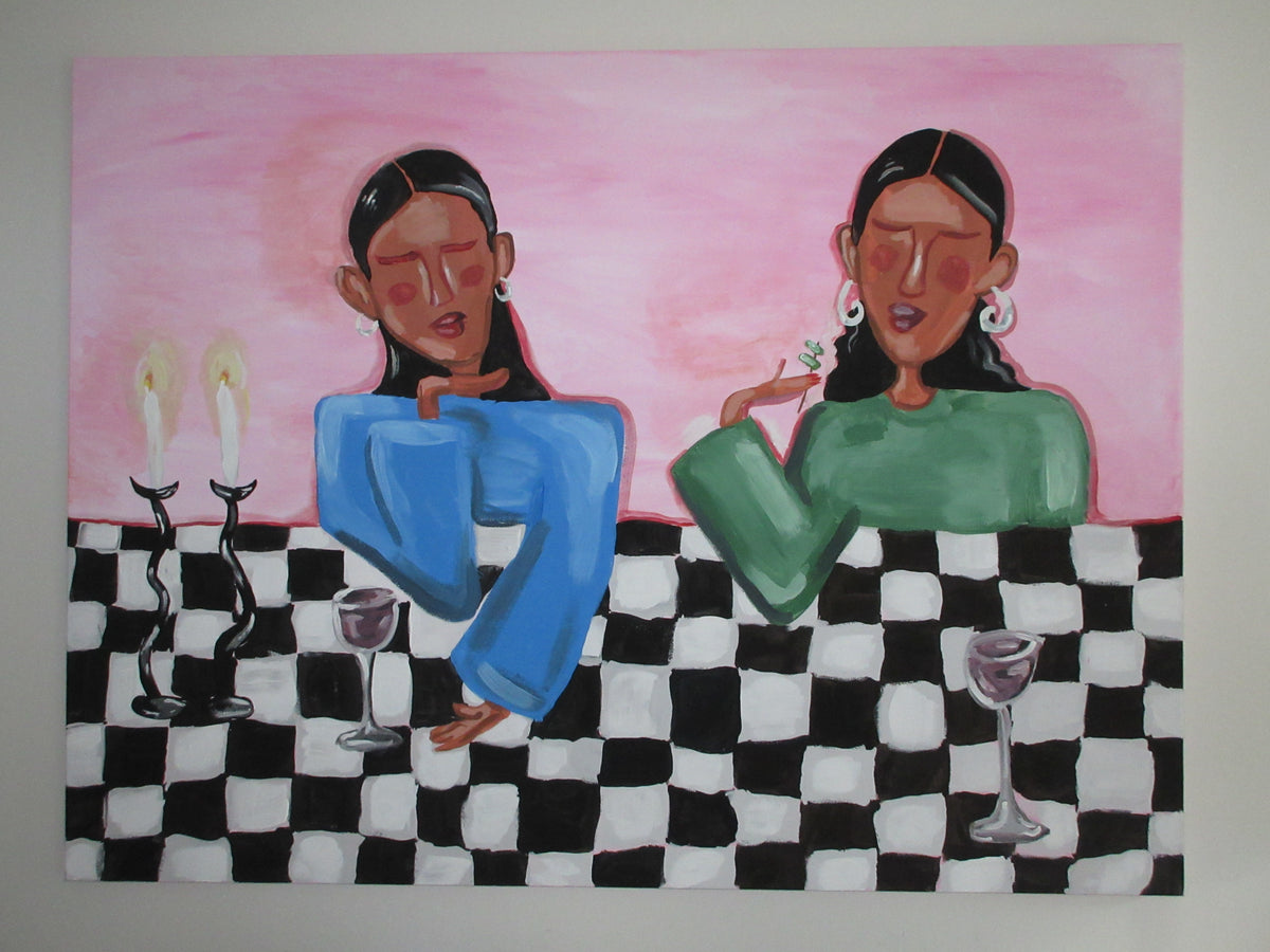 A stylized painting of two women seated at a black-and-white checkered table against a pink background, with candles, wine glasses, and earrings depicted in expressive brushstrokes.