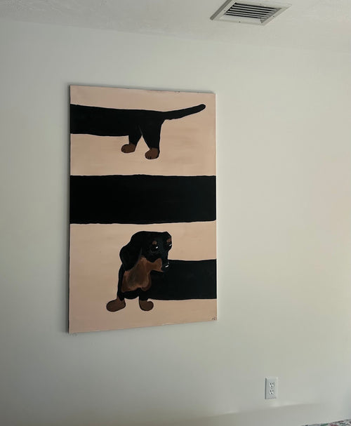 A vertical canvas painting of a dachshund on a beige and black striped background, hanging on a white wall.